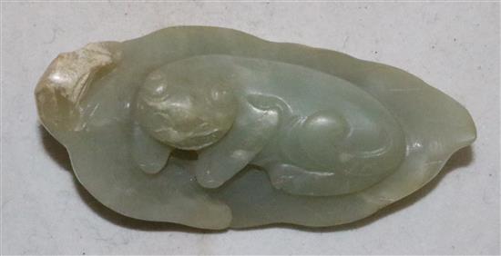 A Chinese celadon jade carving of a recumbent cat on a leaf, 18th / 19th century,